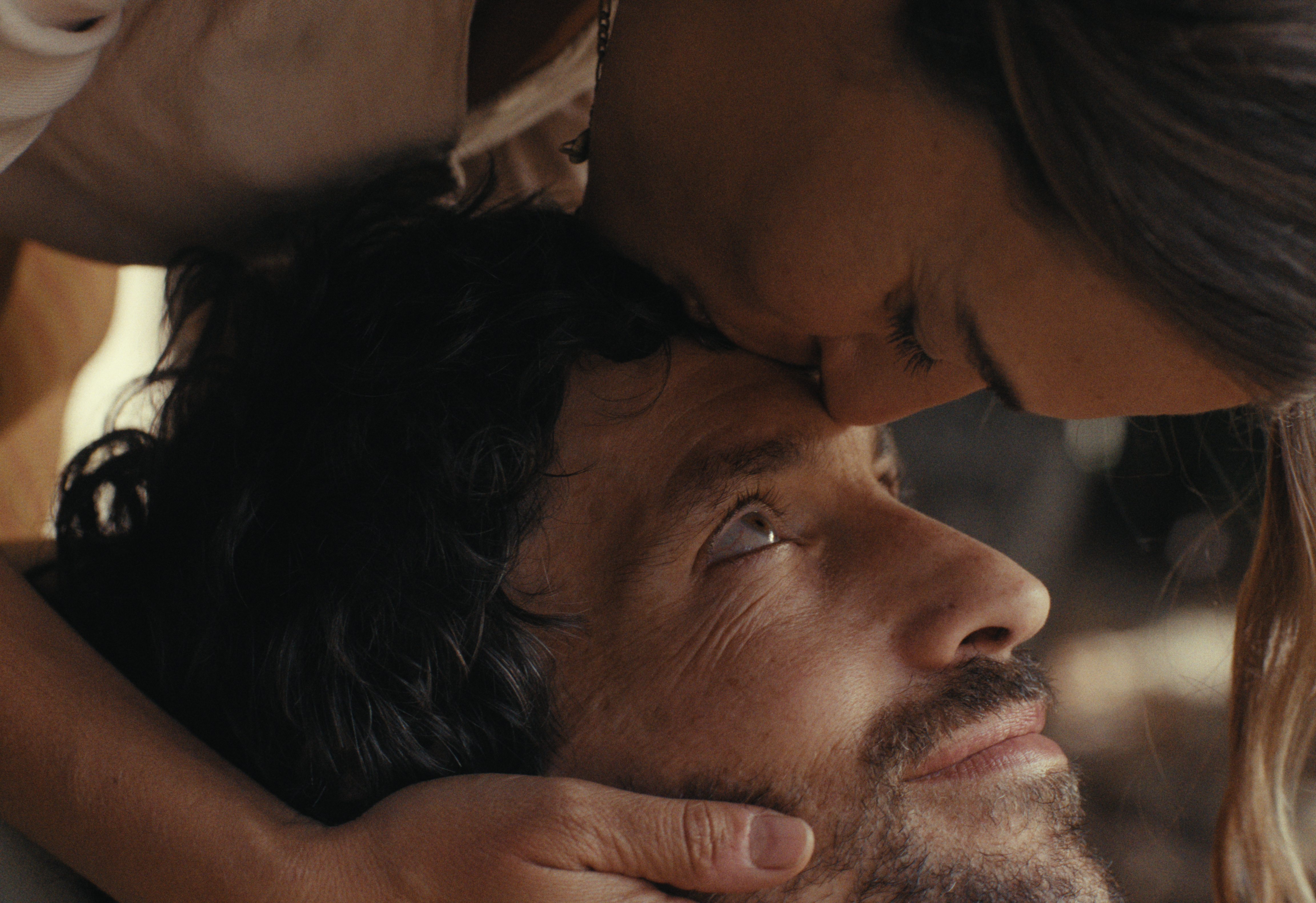 Close family embrace with warm light.